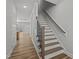 Stairway features wood steps, black metal spindles and a light-filled entry creating an inviting transition between levels at 610 Marshskip Way, Rolesville, NC 27587