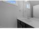 Modern bathroom with dark vanity, quartz countertop, and chrome fixtures at 612 Marshskip Way, Rolesville, NC 27587