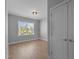 Bright bedroom with wood floors, large window, and double doors at 612 Marshskip Way, Rolesville, NC 27587