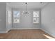 Bright dining area with hardwood floors and modern light fixture at 612 Marshskip Way, Rolesville, NC 27587