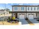 Stylish townhome facade with two-car garage, gray siding, and well-maintained front yard landscaping at 612 Marshskip Way, Rolesville, NC 27587