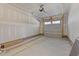 Unfinished garage with overhead door and concrete floor at 612 Marshskip Way, Rolesville, NC 27587