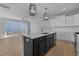 Open concept kitchen with island, stainless steel appliances, and access to backyard at 612 Marshskip Way, Rolesville, NC 27587