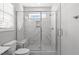 Large walk-in shower with marble tile and glass enclosure at 612 Marshskip Way, Rolesville, NC 27587