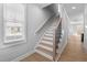 Staircase with light wood treads and black metal balusters at 612 Marshskip Way, Rolesville, NC 27587