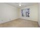Well-lit bedroom with neutral walls and carpet at 617 Eyam Hall Ln, Apex, NC 27502