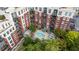 Bird's-eye view of an elegant red brick condo with balconies overlooking a serene pool and landscaped courtyard at 618 N Boylan Ave # 826, Raleigh, NC 27603
