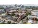 A scenic aerial view captures this condo building nestled among city streets and lush greenery, with city skyline views at 618 N Boylan Ave # 826, Raleigh, NC 27603