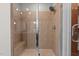 Walk-in shower featuring neutral colored tile, a glass door, and a shower bench at 618 N Boylan Ave # 826, Raleigh, NC 27603