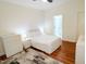 Bright bedroom with a queen-size bed, hardwood floors, and en-suite bathroom at 620 Rollins Mill Rd, Holly Springs, NC 27540