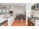 Modern kitchen with stainless steel appliances, granite counters, and an adjacent dining area at 620 Rollins Mill Rd, Holly Springs, NC 27540