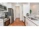 Modern kitchen with stainless steel appliances and granite countertops at 620 Rollins Mill Rd, Holly Springs, NC 27540