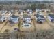 Wide shot of the neighborhood with several homes and wooded area at 7152 Rex Rd, Holly Springs, NC 27540