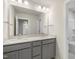 Double vanity bathroom with gray cabinets and a mirror at 82 Gin Branch Rd, Wendell, NC 27591