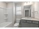 Bathroom with shower/tub combo and gray vanity at 82 Gin Branch Rd, Wendell, NC 27591