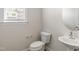 Small bathroom with pedestal sink and toilet at 82 Gin Branch Rd, Wendell, NC 27591