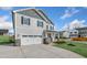 Two-story home showcasing a large, white two-car garage and stone accents at 82 Gin Branch Rd, Wendell, NC 27591