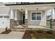 Covered front porch with stone columns and a charming front door at 82 Gin Branch Rd, Wendell, NC 27591