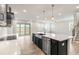 Open concept kitchen with island, stainless steel appliances, and access to backyard at 82 Gin Branch Rd, Wendell, NC 27591