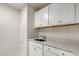 Laundry room with white cabinets and sink at 82 Gin Branch Rd, Wendell, NC 27591