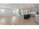 Open living room with hardwood floors, staircase, and kitchen view at 82 Gin Branch Rd, Wendell, NC 27591