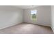 Bright bedroom with carpeted floor and large window at 821 Rhino Bnd, Oxford, NC 27565