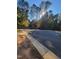 Street view of a residential community, showcasing the paved road and surrounding nature at 8717 Little Deer Ln, Raleigh, NC 27613