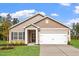 New construction home with two-car garage and landscaped lawn at 910 Rhino Bnd, Oxford, NC 27565