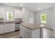 Bright kitchen with a large island, granite countertops, stainless steel appliances, and plentiful natural light at 910 Rhino Bnd, Oxford, NC 27565