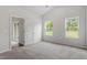 Main bedroom with carpet, two windows and access to patio at 910 Rhino Bnd, Oxford, NC 27565