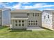 View of the backyard showing the patio, lawn, and the exterior of the house at 9164 Dupree Meadow Dr # 14, Angier, NC 27501