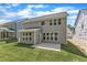 Back exterior featuring a concrete patio and spacious lawn at 9164 Dupree Meadow Dr # 14, Angier, NC 27501