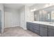 Bright bathroom featuring a double sink vanity, shower, and a tile floor at 9164 Dupree Meadow Dr # 14, Angier, NC 27501