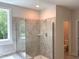 Bathroom showcasing a glass-enclosed shower with tiled walls and a window at 9164 Dupree Meadow Dr # 14, Angier, NC 27501