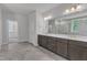 Bathroom featuring stone tile flooring, and vanity, framed mirror, and tiled shower at 9164 Dupree Meadow Dr # 14, Angier, NC 27501