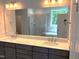 Bathroom featuring double sinks, a large mirror, and natural light at 9164 Dupree Meadow Dr # 14, Angier, NC 27501