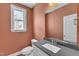 Cozy bathroom featuring gray countertops, white cabinets, and a window view at 9164 Dupree Meadow Dr # 14, Angier, NC 27501