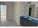 Bright bathroom featuring a double vanity with gray cabinets and a large mirror at 9164 Dupree Meadow Dr # 14, Angier, NC 27501