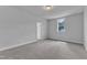 Well-lit bedroom features neutral walls, plush carpeting, light fixture, and large window at 9164 Dupree Meadow Dr # 14, Angier, NC 27501