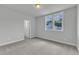 Bright bedroom featuring carpeted floors, a large window, and an open doorway at 9164 Dupree Meadow Dr # 14, Angier, NC 27501