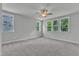 Spacious bedroom with plush carpeting, neutral walls, ceiling fan and large window at 9164 Dupree Meadow Dr # 14, Angier, NC 27501