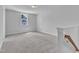 Bright bedroom with large window, neutral walls, plush carpeting and stairway at 9164 Dupree Meadow Dr # 14, Angier, NC 27501