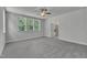 Spacious bedroom with plush carpeting, neutral walls, ceiling fan, bathroom access and large window at 9164 Dupree Meadow Dr # 14, Angier, NC 27501