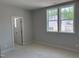 Bedroom featuring two windows providing ample natural light, with doorway to a walk-in closet at 9164 Dupree Meadow Dr # 14, Angier, NC 27501