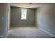 Empty bedroom showing a standard window and empty electrical sockets, allowing for personalized design at 9164 Dupree Meadow Dr # 14, Angier, NC 27501