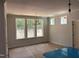 Bright dining area featuring large windows providing natural light, next to kitchen island with dining space at 9164 Dupree Meadow Dr # 14, Angier, NC 27501