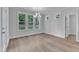 Bright dining room with ample windows and a modern chandelier at 9164 Dupree Meadow Dr # 14, Angier, NC 27501