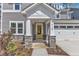 Inviting entryway with a bright yellow door, stone accents, and neutral colors at 9164 Dupree Meadow Dr # 14, Angier, NC 27501
