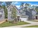 Charming two-story home with gray siding, stone accents, and a well-manicured lawn at 9164 Dupree Meadow Dr # 14, Angier, NC 27501