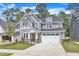 Charming two-story home with gray siding, stone accents, and a well-manicured lawn at 9164 Dupree Meadow Dr # 14, Angier, NC 27501